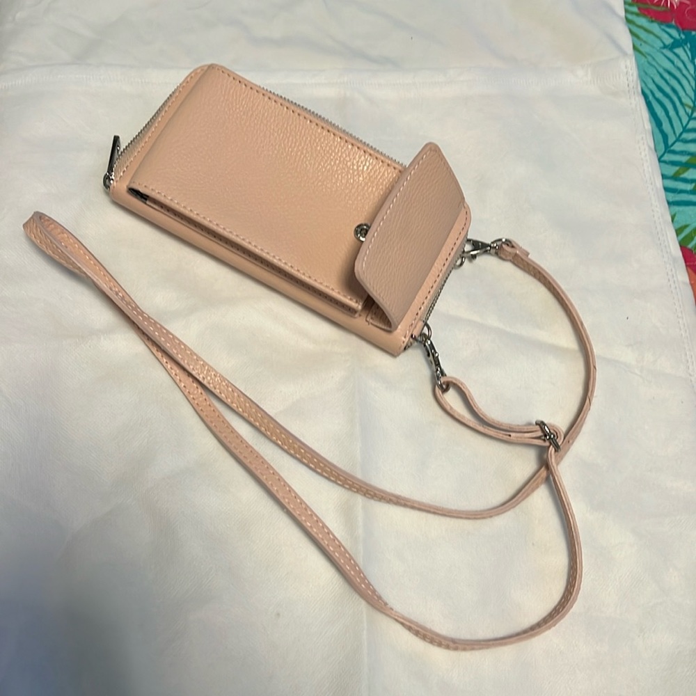 Carnation pink wallet purse with 45” adjustable strap. Cell phone holder.